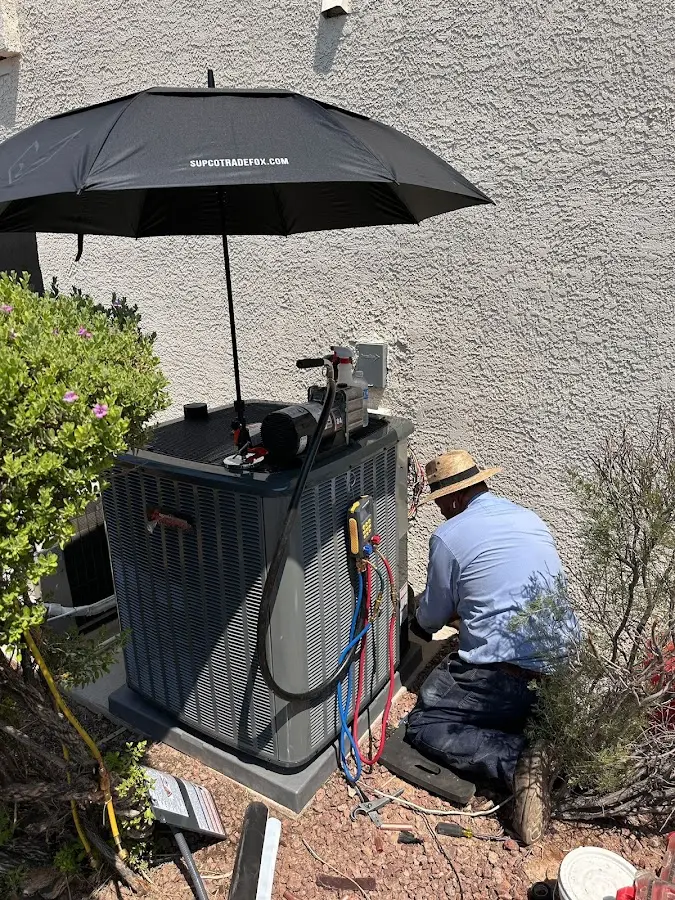 HVAC technician performing outdoor AC maintenance in West Haven